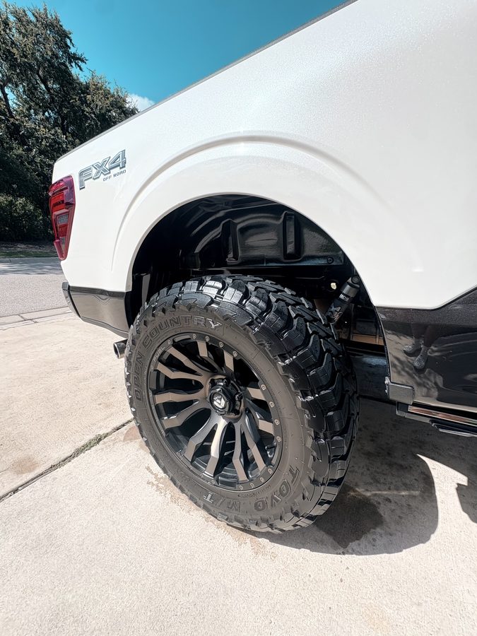 Lifted Ford F-150 FX4 with dressed Toyo tires and Fuel wheels after an exterior detail