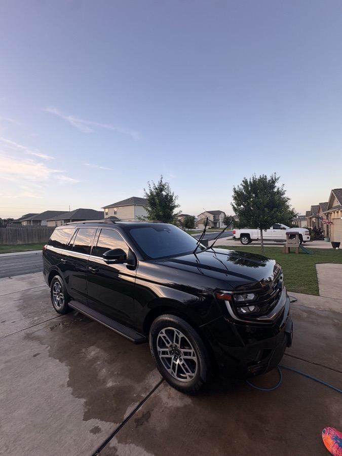 Black Ford Expedition with a deep gloss finish at dusk