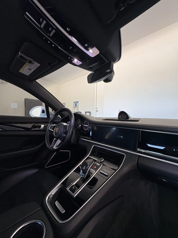 Deep cleaned Porsche Panamera cockpit with black leather and center console detailed