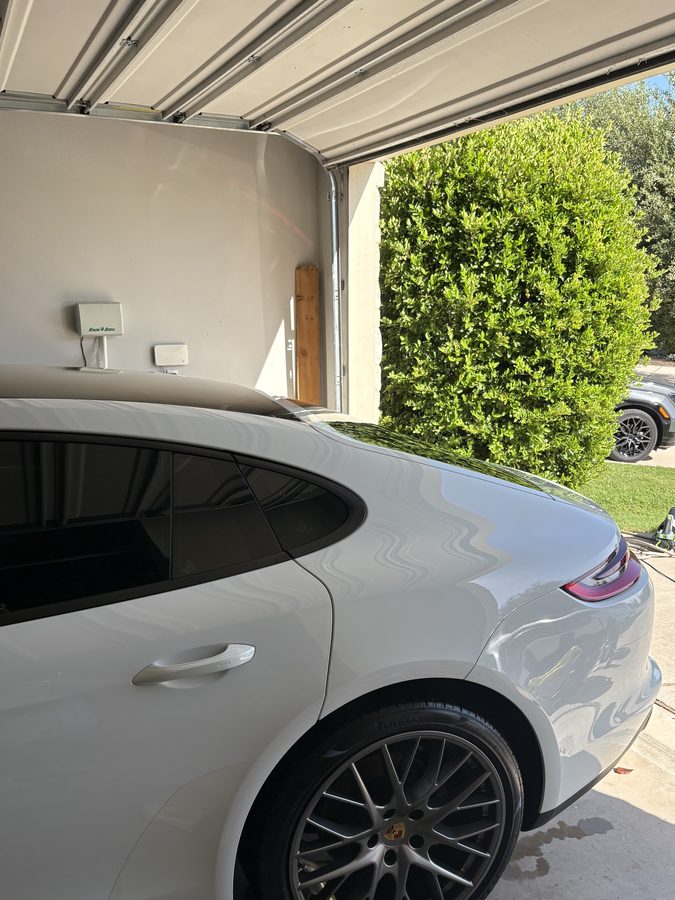 White Porsche Panamera rear quarter panel and wheel with a deep gloss finish
