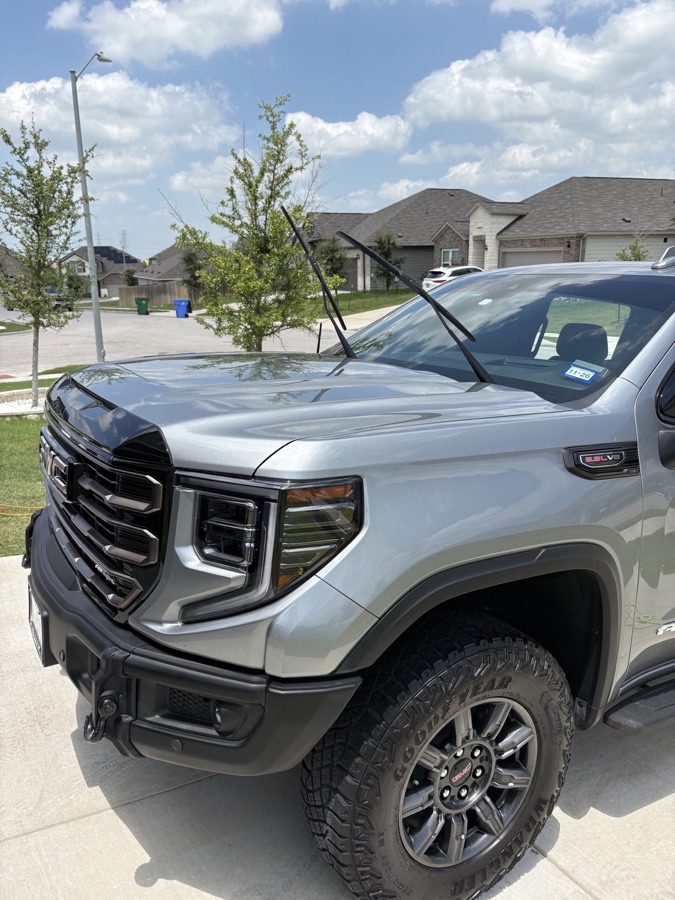 Gray GMC Sierra AT4X with polished paint and wheels after an exterior detail