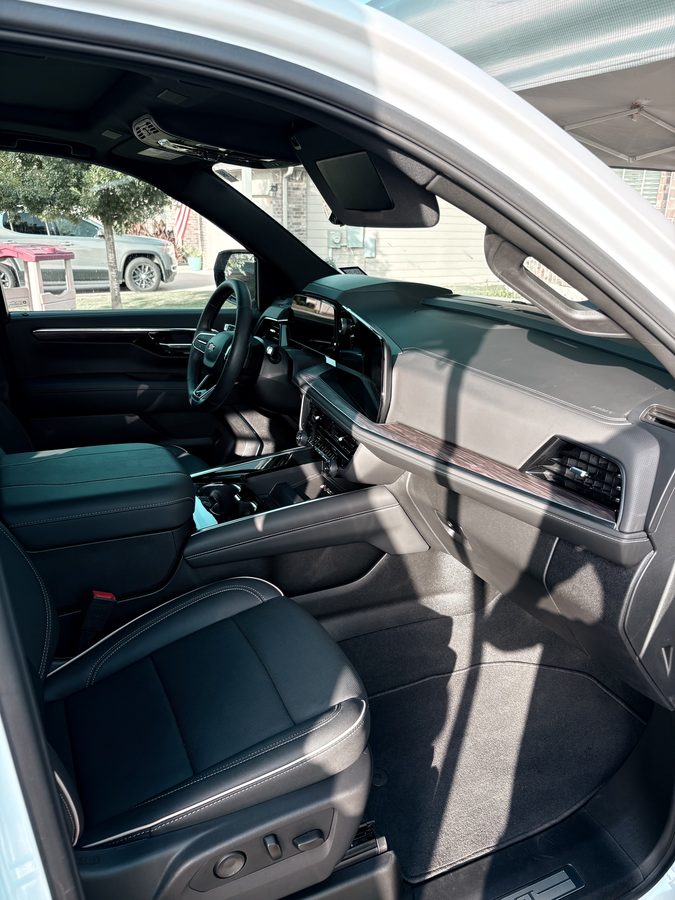 Deep cleaned Chevrolet Tahoe front cabin with black leather seats after an interior detail