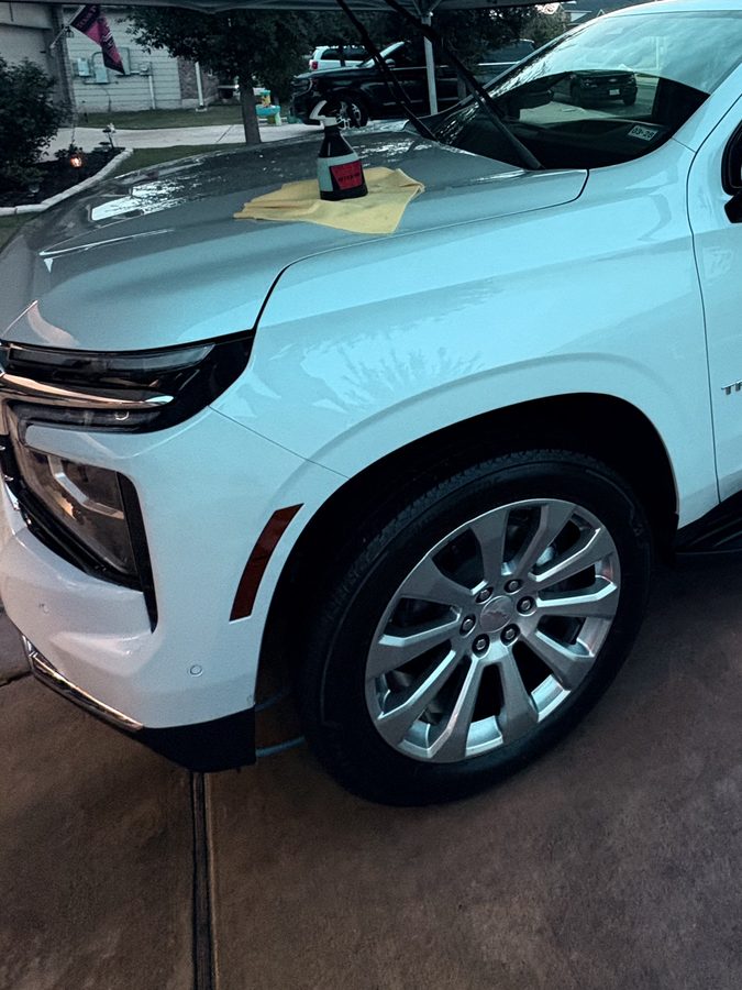 White Chevrolet Tahoe front three quarter with a deep gloss finish after an exterior detail