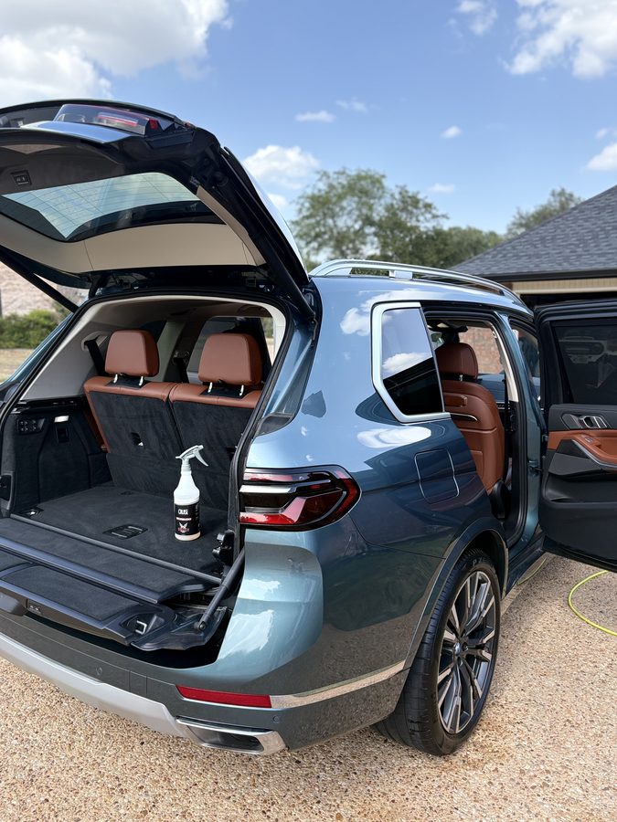 BMW X7 cargo area and cognac leather third row cleaned during an interior detail