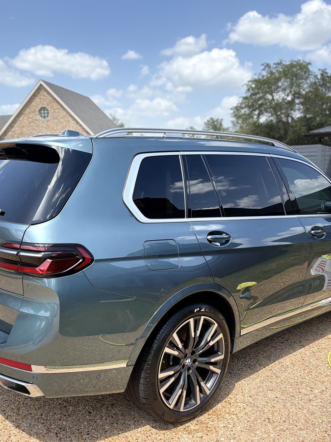 Blue BMW X7 xDrive40i rear quarter and wheel after an exterior detail