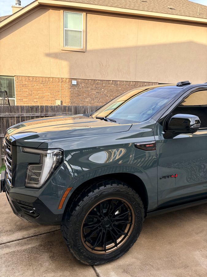 Slate blue GMC Yukon AT4 with a fresh gloss finish after an exterior detail